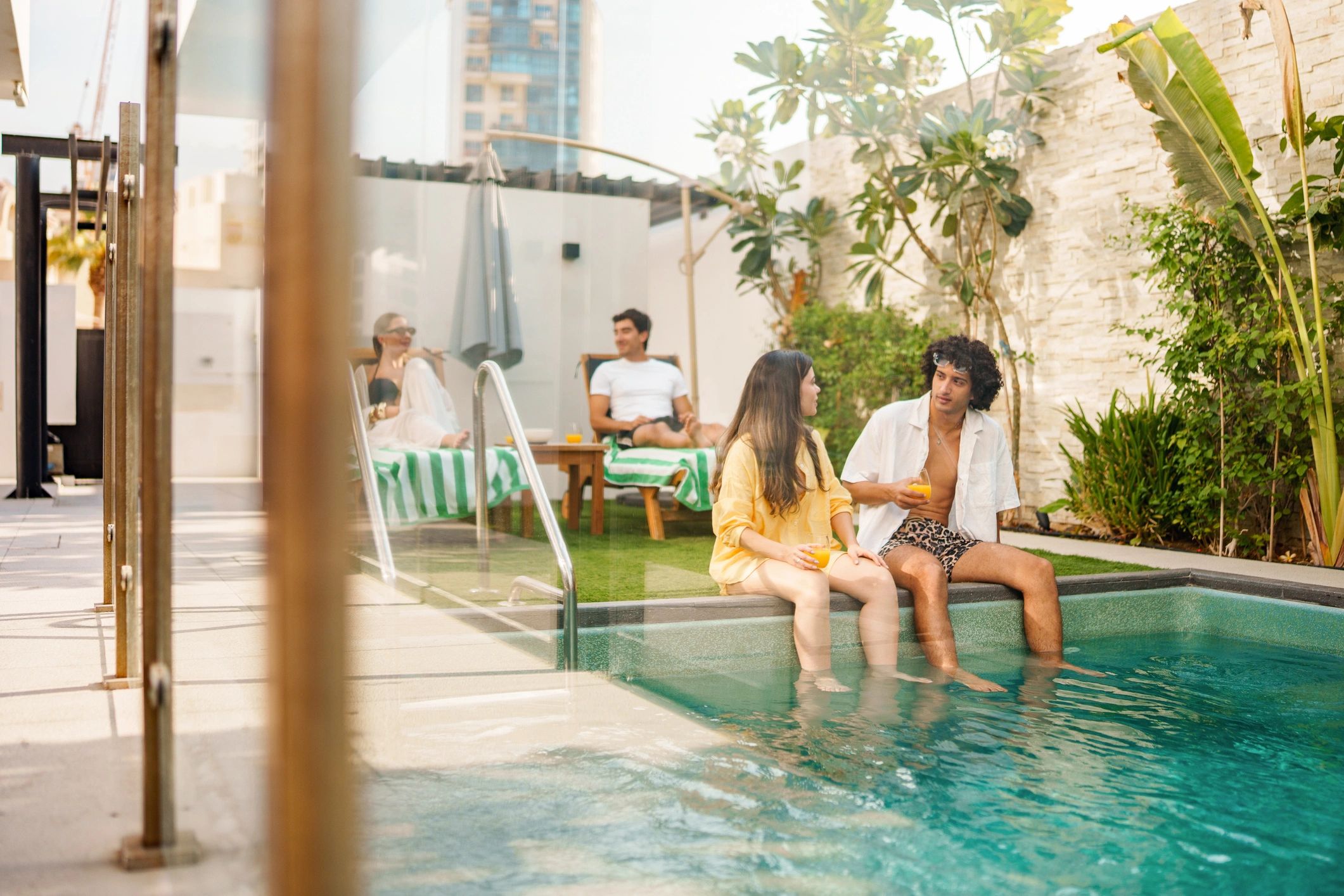 Couple relaxing by a private swimming pool